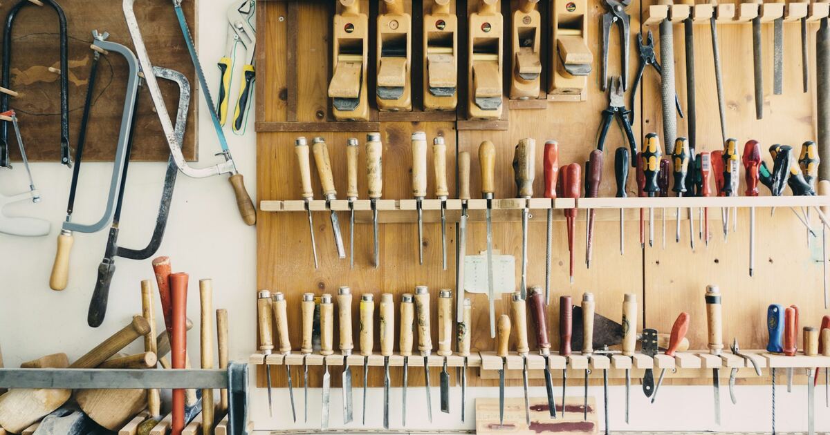 Well-organized garage workshop with power tools and equipment on a pegboard wall